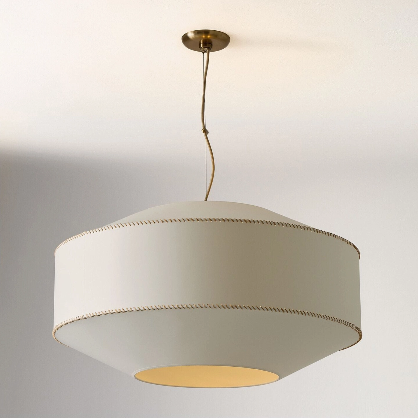 Brass suspension hardware and whipstitch trim close-up detail of linen fabric pendant light