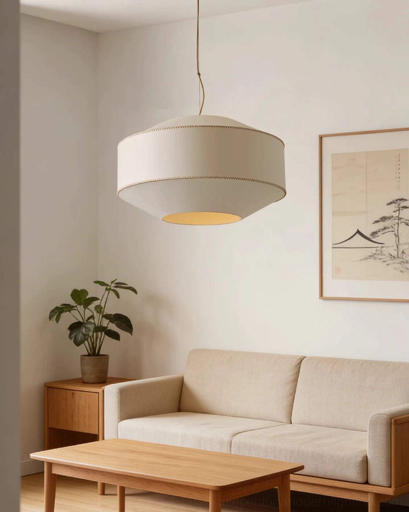 Modern pendant light in japandi living room above sofa and coffee table with neutral warm décor