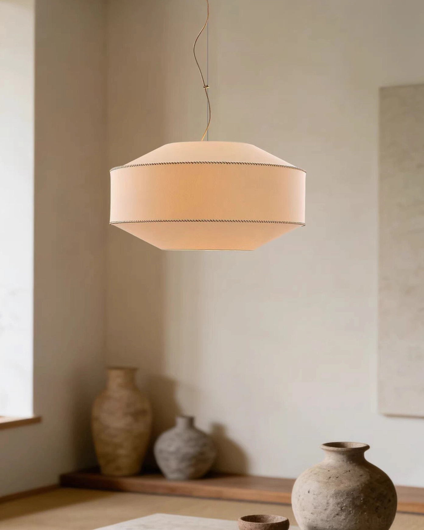 Mid-century modern pendant light in japandi living space with ceramic vases and natural décor