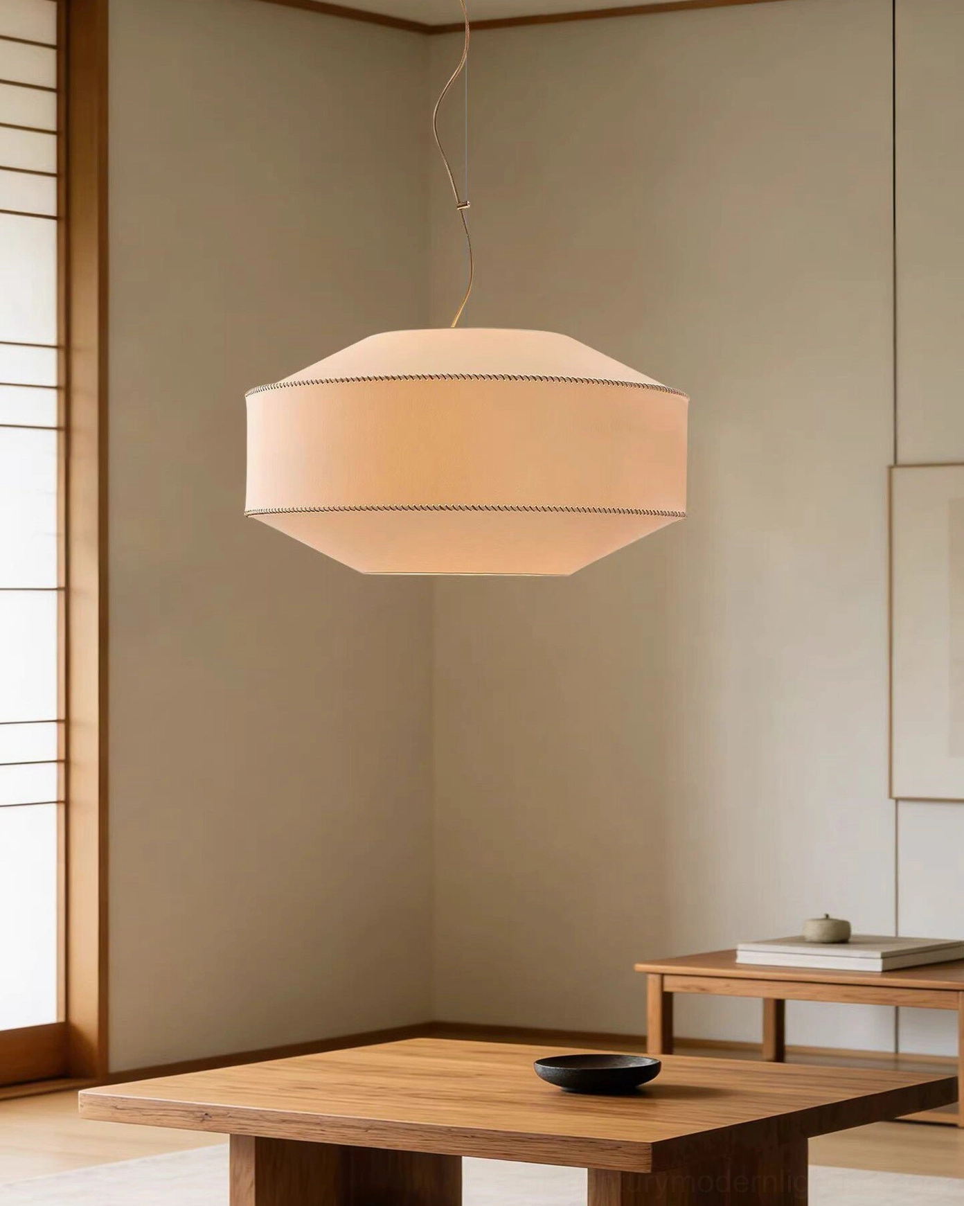Warm linen drum pendant light in traditional Japanese-style dining nook with natural wood furniture