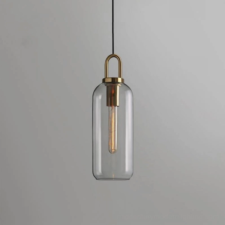 Small diameter clear glass smoked pendant lamp with visible warm light source in bedroom setting