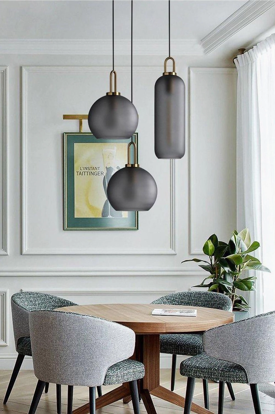 Small diameter smoked glass pendant showing sculptural form and brass metal suspension hardware