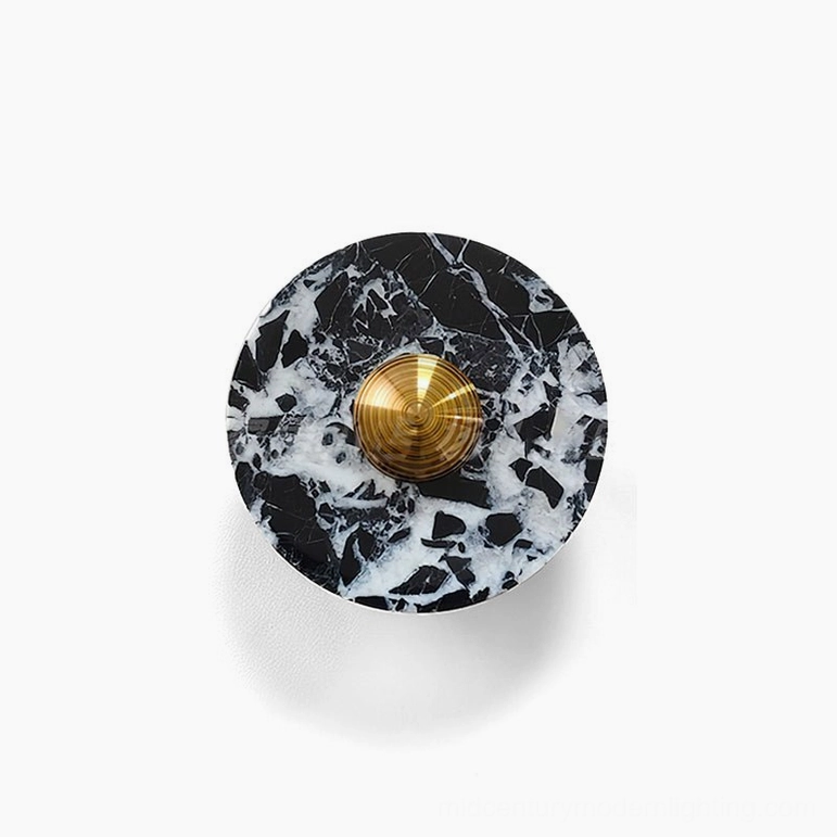 Marble wall lamp in smaller diameter size showing geometric marble disc with chrome accent fixture