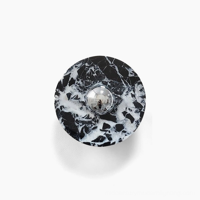 Marble wall lamp in smaller size with subtle veining patterns and geometric circular design