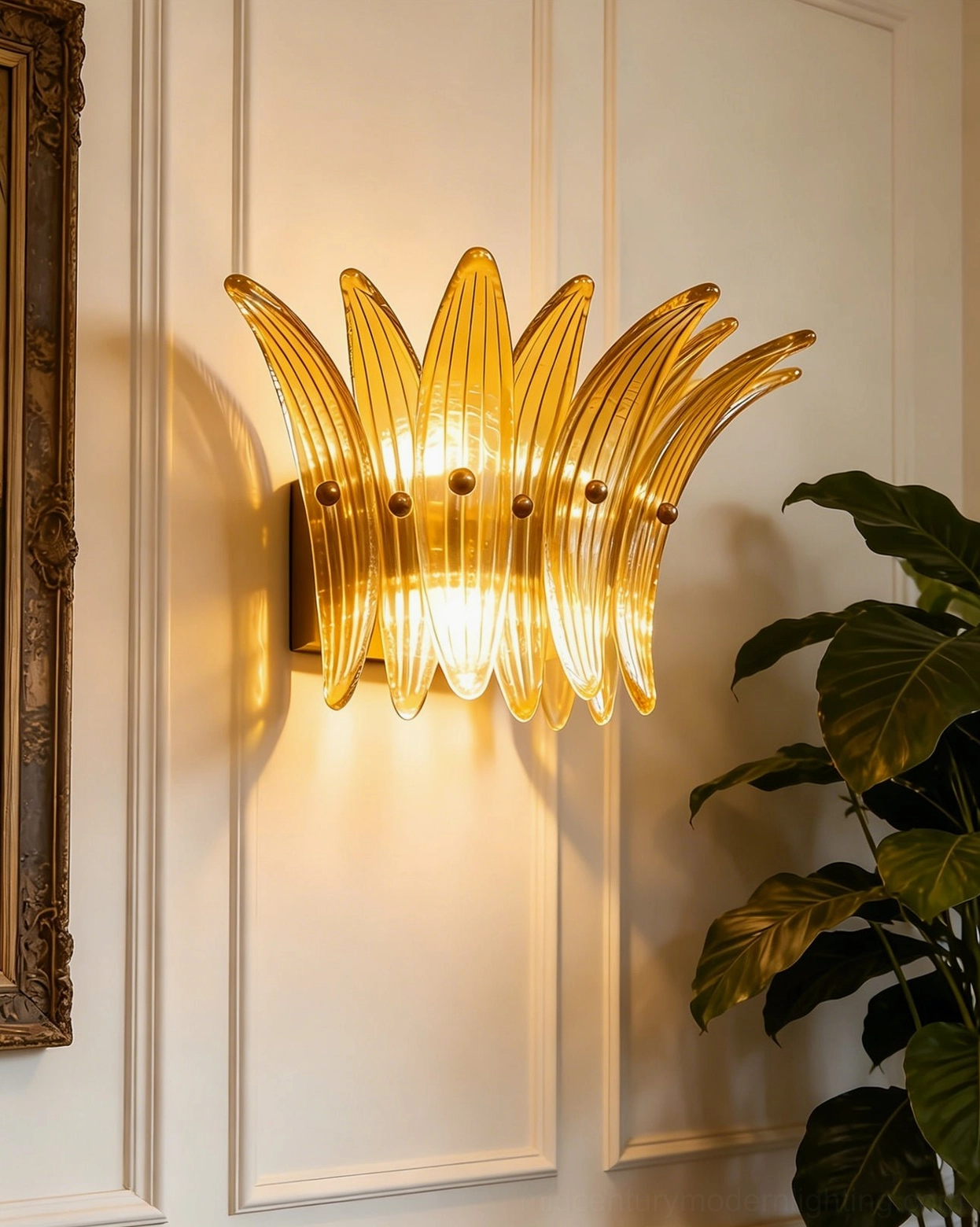 Amber Smeralda wall sconce with bright warm illumination and brass accents in compact petal form