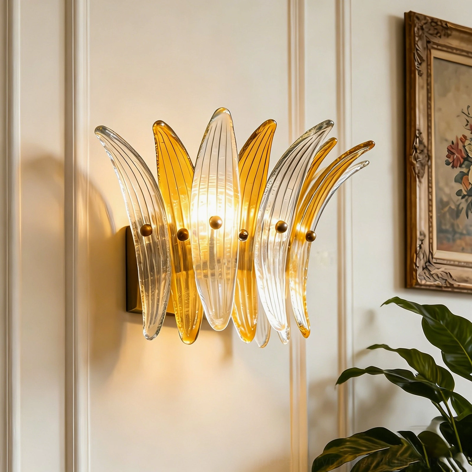 Clear and amber Smeralda wall sconce illuminated on vintage paneled wall with framed artwork