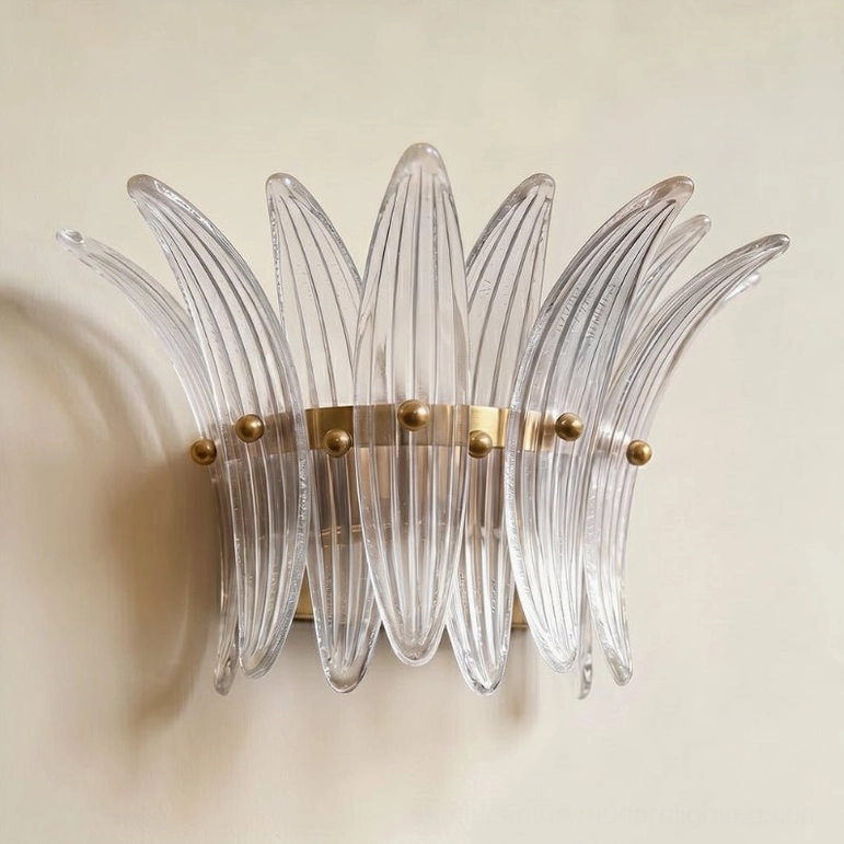 Smeralda wall sconce clear and gold finish variant mounted and illuminated