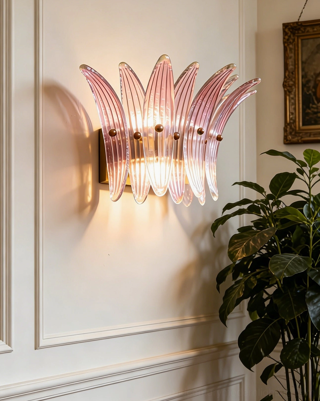 Illuminated Smeralda wall sconce with fluted petal glass design casting dramatic shadows
