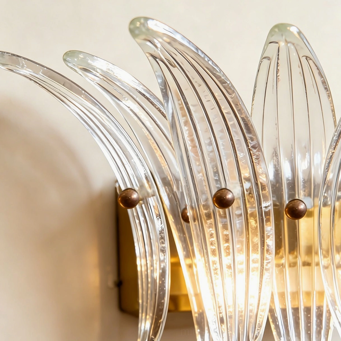 Smeralda wall sconce detail shot of fluted glass ribbed surface and brass mounting hardware