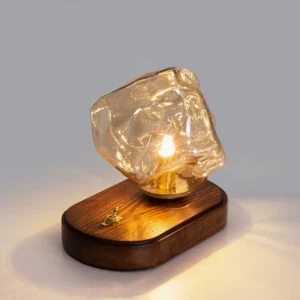 Smoke gray hand-blown glass table lamp shade close-up detail showing organic textured surface and interior brass socket