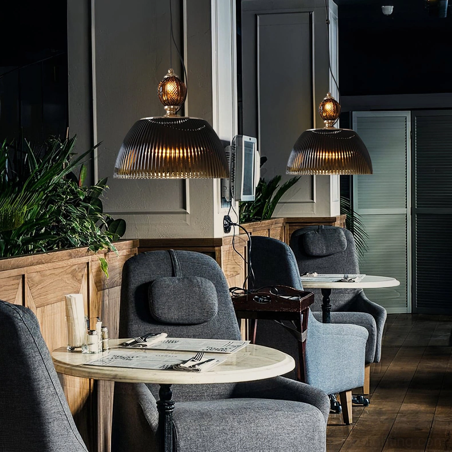 Ribbed glass pendant lamp in smoky brown creating dimensional light patterns in minimalist contemporary space