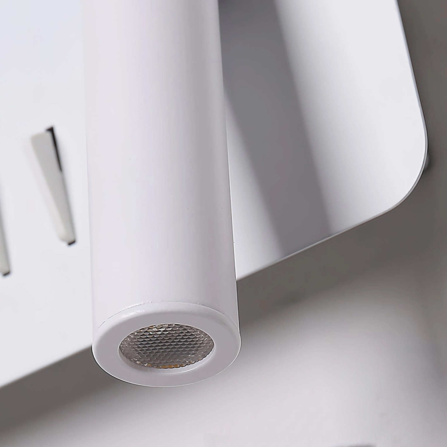 Snotra wall lamp close-up detail showing honeycomb diffuser and metal switch