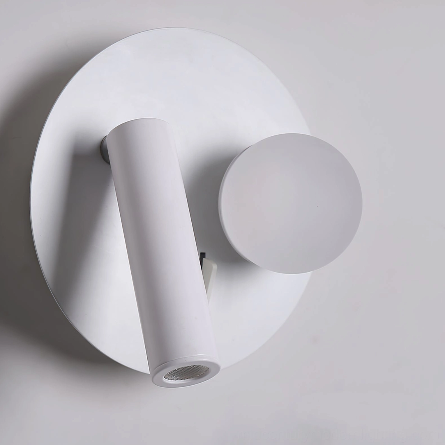Snotra round base wall lamp front view showing matte white finish and mounting hardware