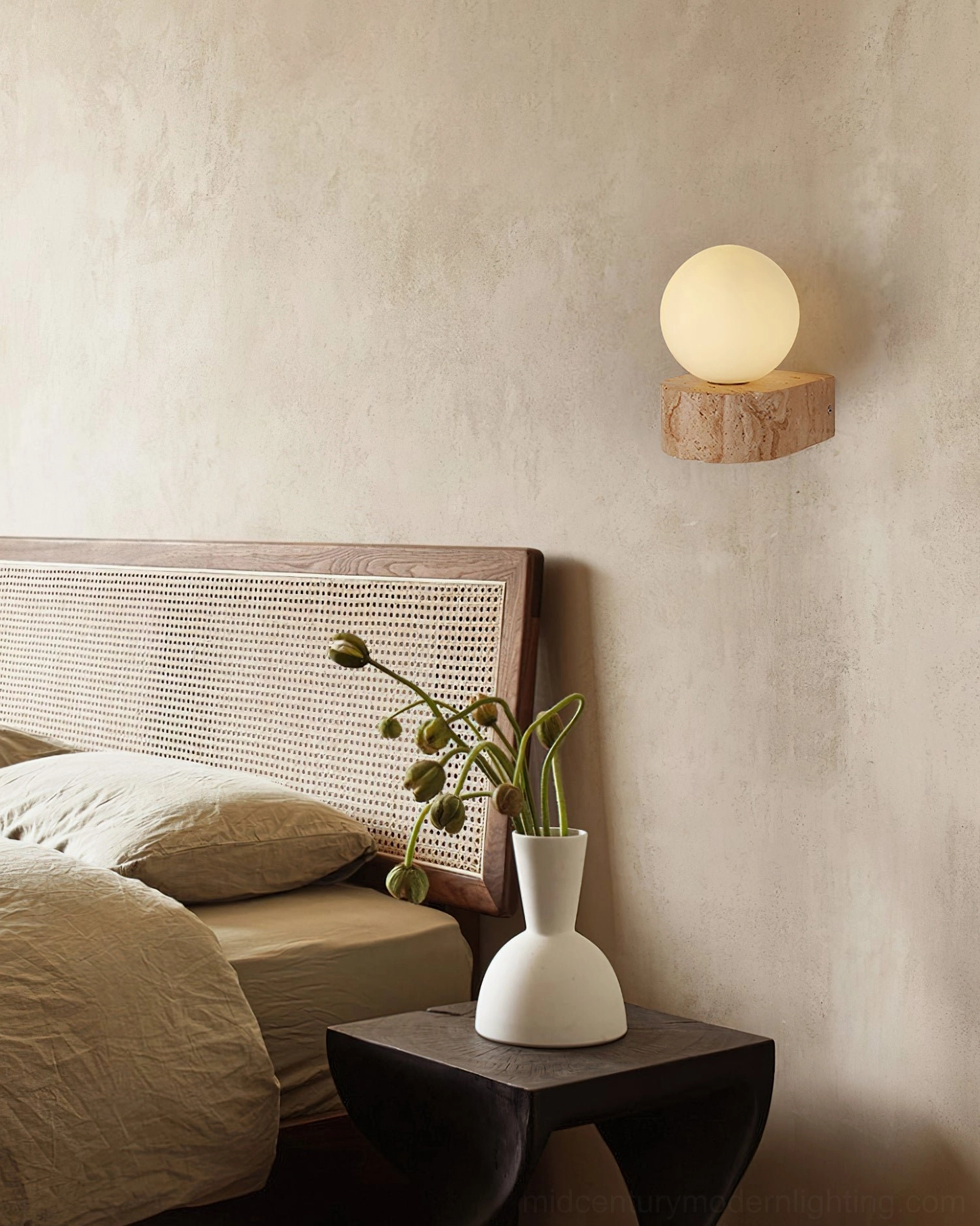 Solace globe wall lamp beside wabi-sabi rattan headboard in minimalist bedroom