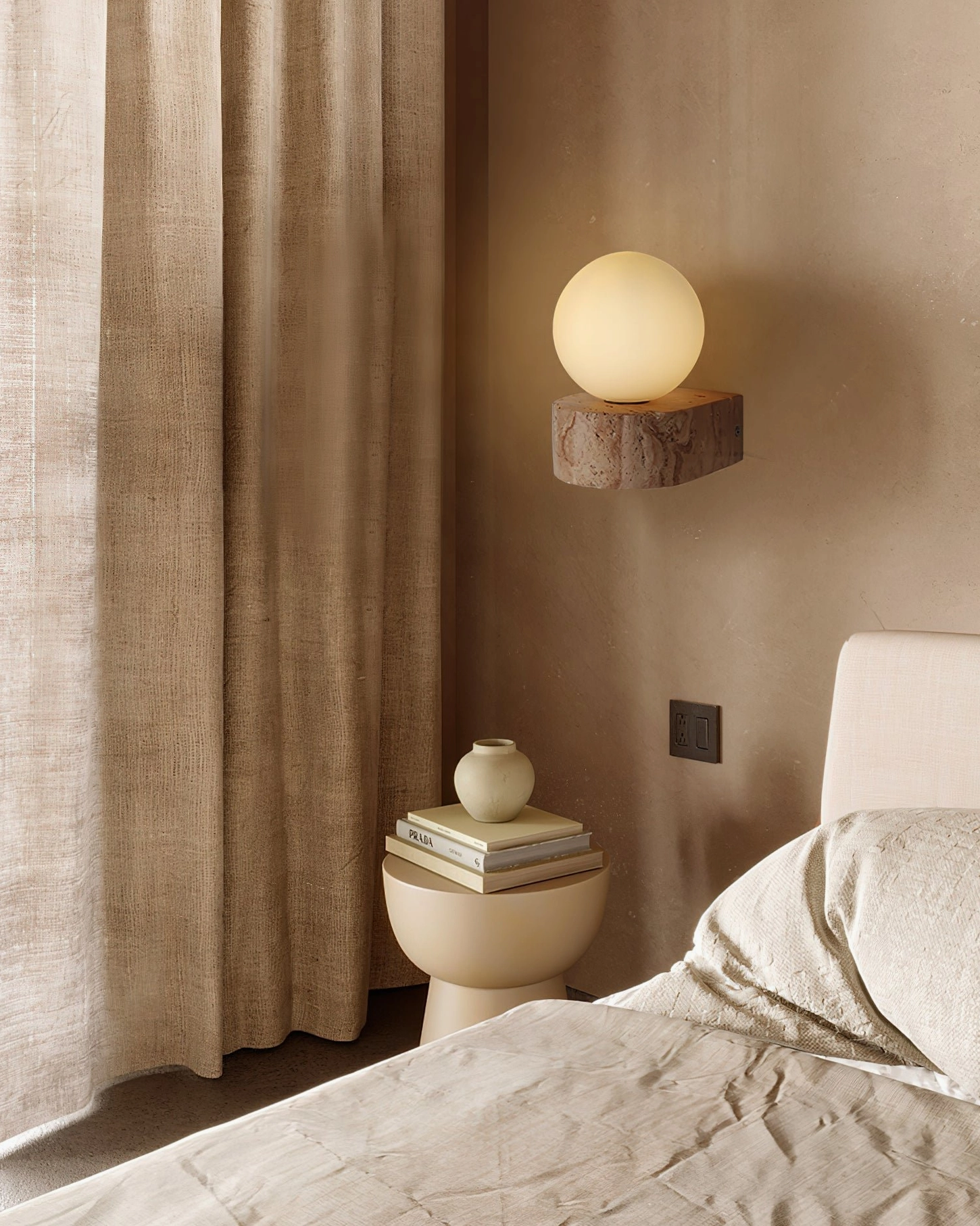 Lit travertine globe wall sconce glowing bedside with natural stone and frosted glass