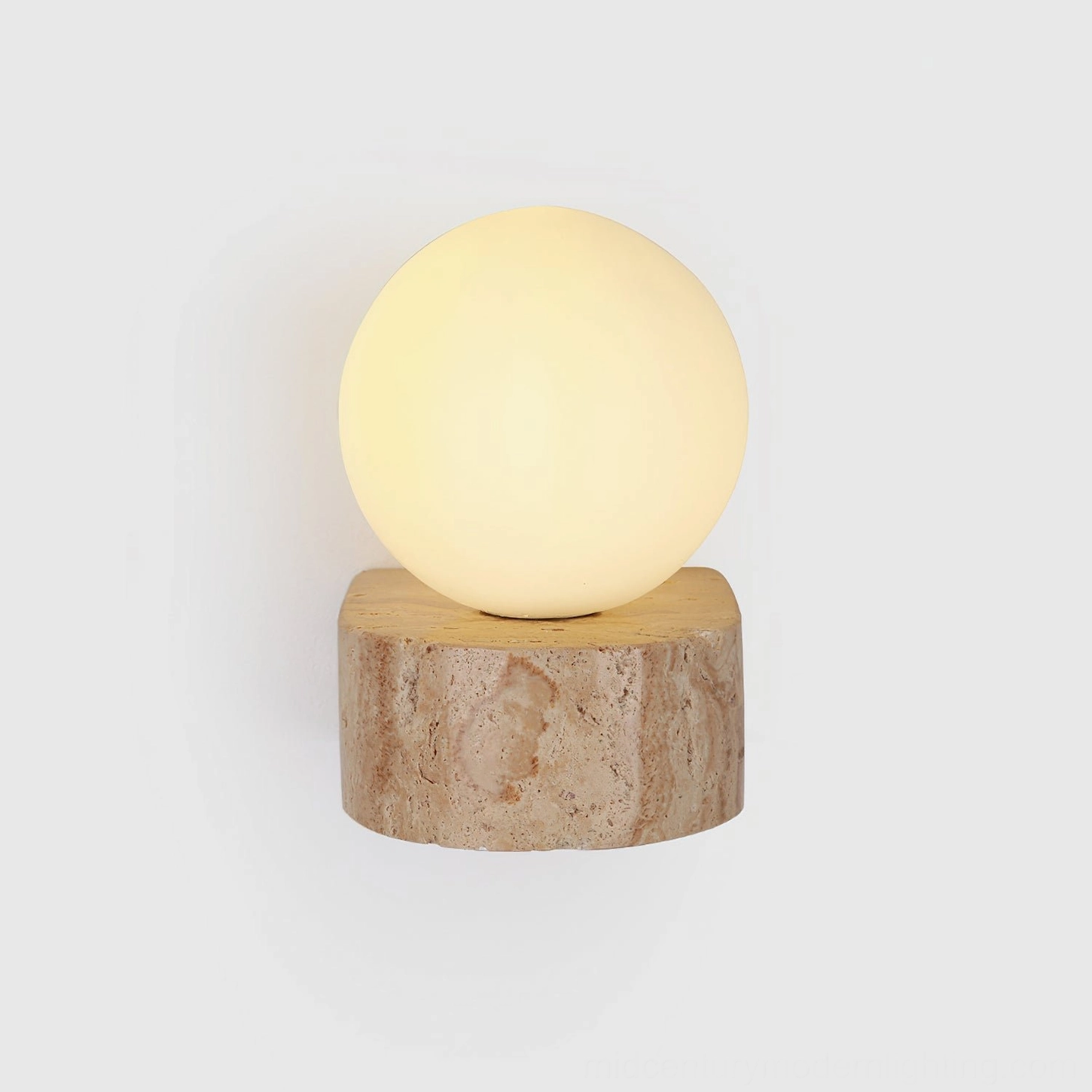 Solace minimalist wall light fixture showing travertine base and spherical globe design