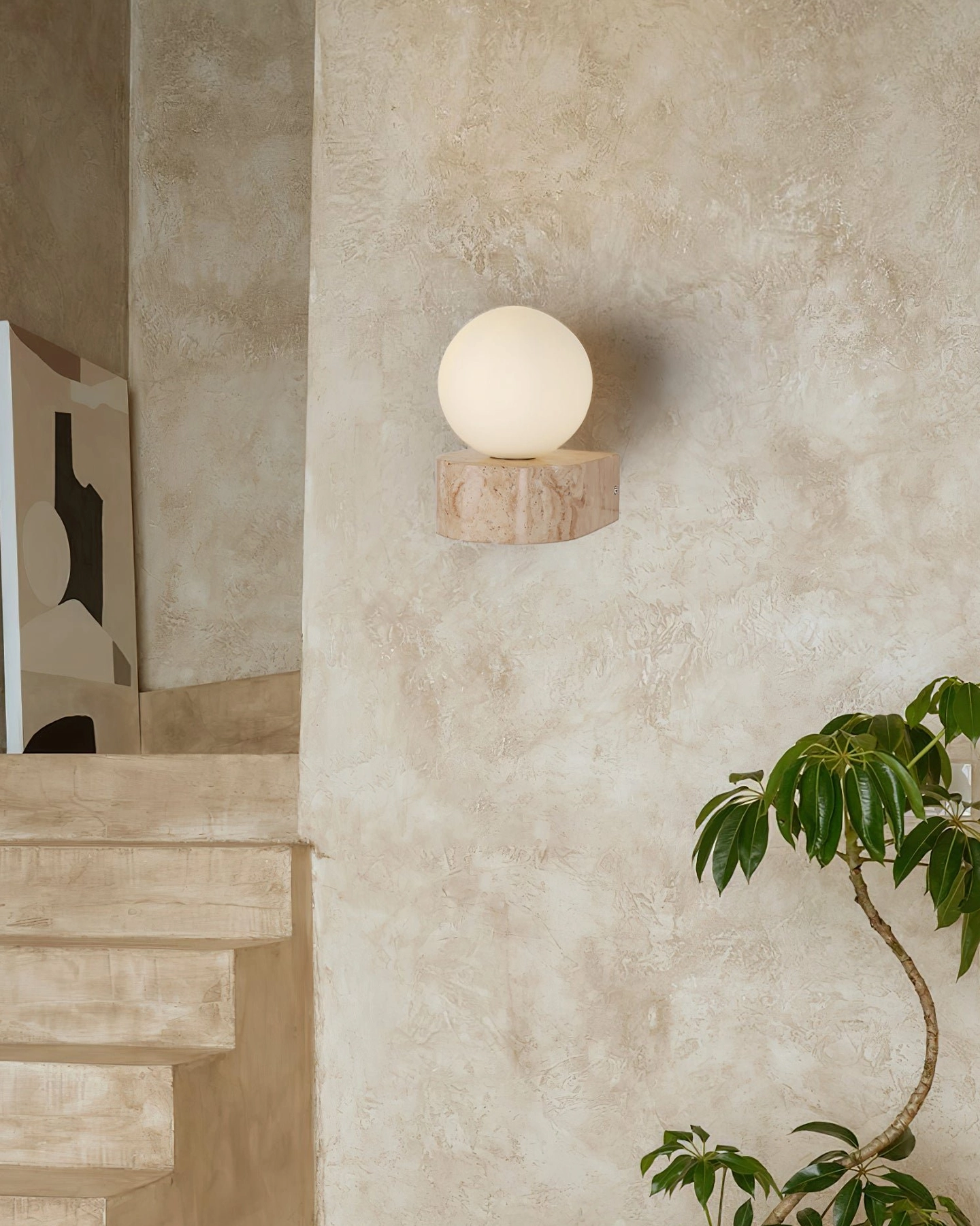 Solace travertine wall sconce in entryway with matte white glass diffuser