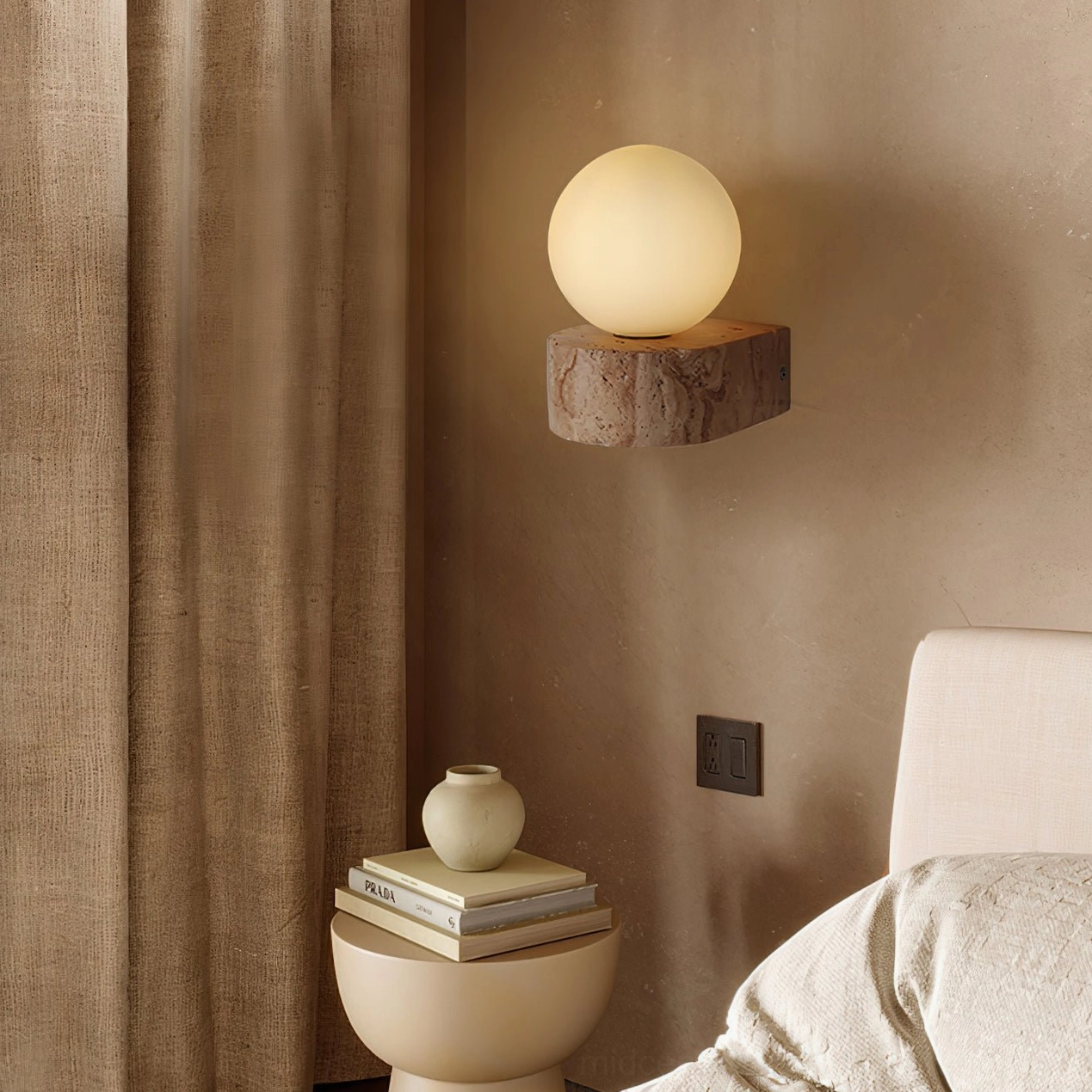 Lit solace wall light in bedroom corner creating warm ambient glow with natural stone base