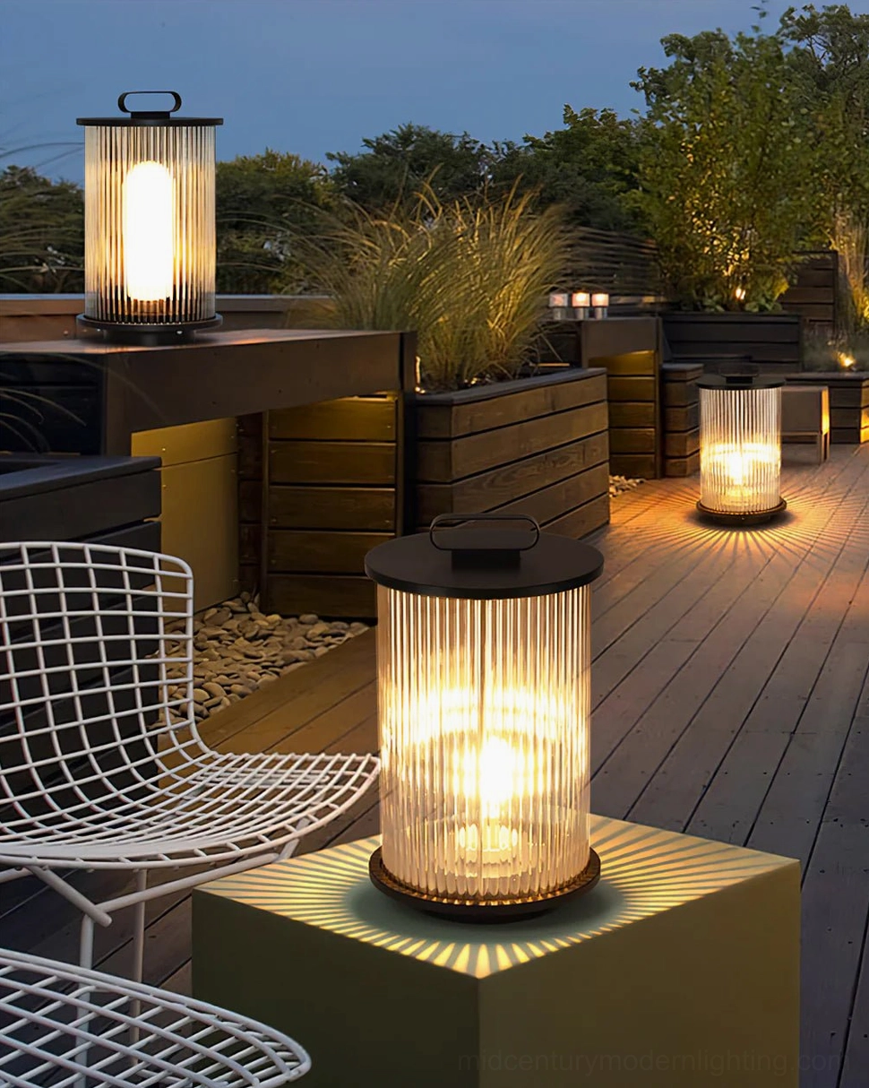 Solar lantern lamps placed on side table and deck floor in wooden rooftop outdoor kitchen area
