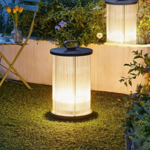 Solar lantern table lamp with warm glowing light placed on grass in backyard garden setting