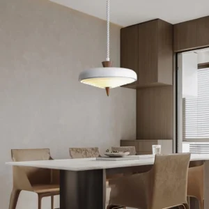 Soleil mid-century pendant lamp installed above dining table in modern warm neutral interior with dining set