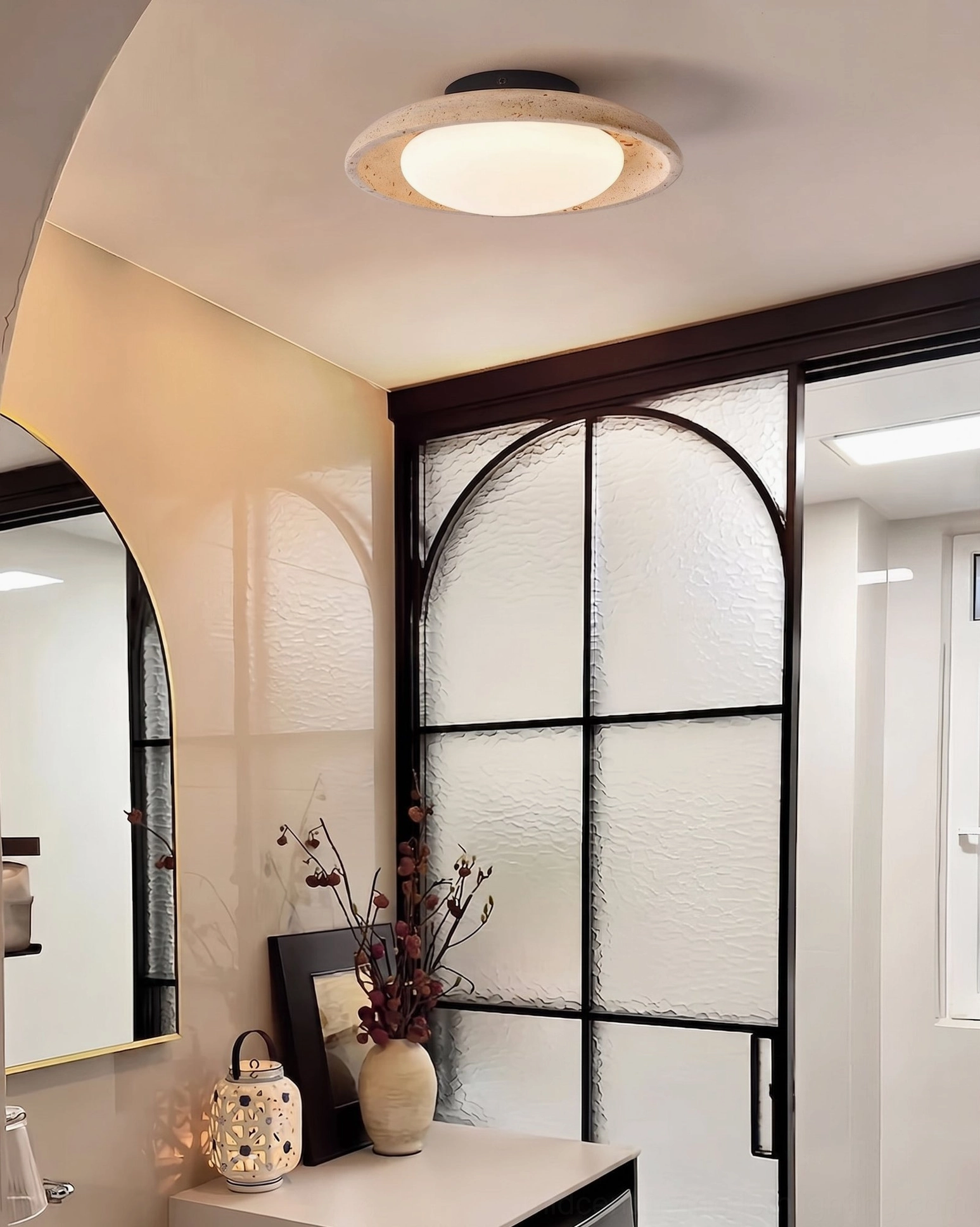 Solis Travertine Ceiling Mount installed in modern luxury bathroom overhead ceiling view warm minimalist interior design