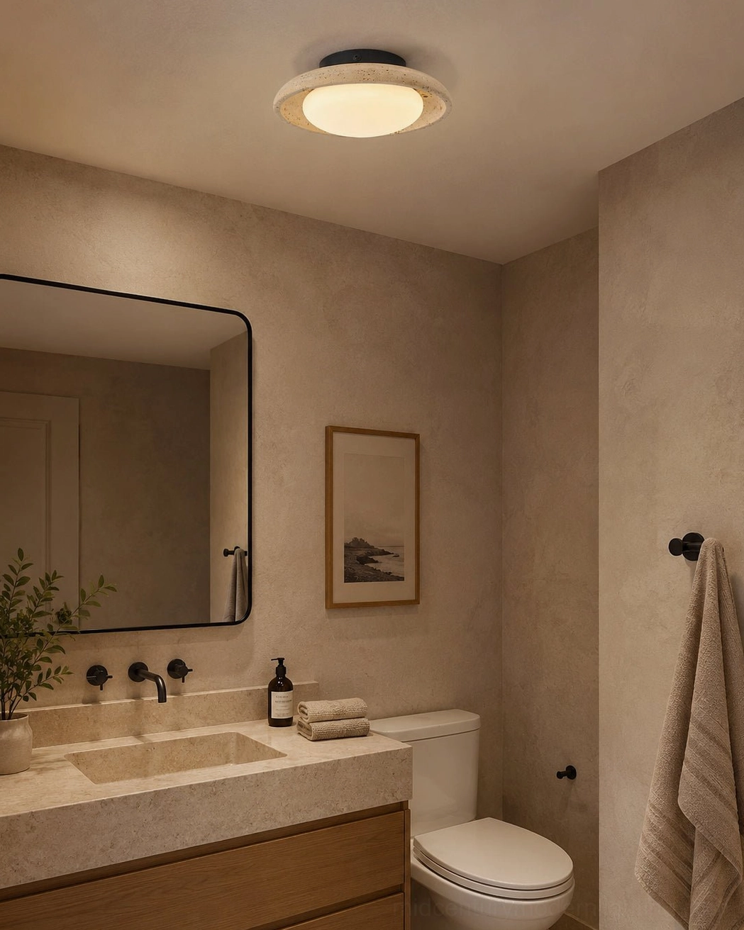 Solis Travertine Ceiling Mount in master bathroom overhead view with wooden vanity rounded mirror warm brown toned decor