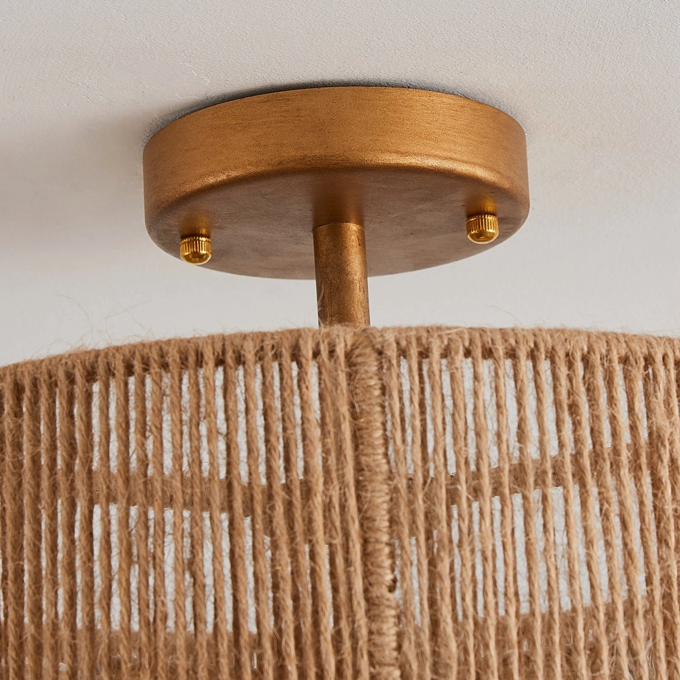 Bottom mounting base of Solmaz lamp showing brushed brass metal finish and E26 socket assembly detail