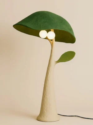 Soloma floor lamp straight front view featuring matte beige body, green shade, and decorative leaf side accent in warm studio lighting