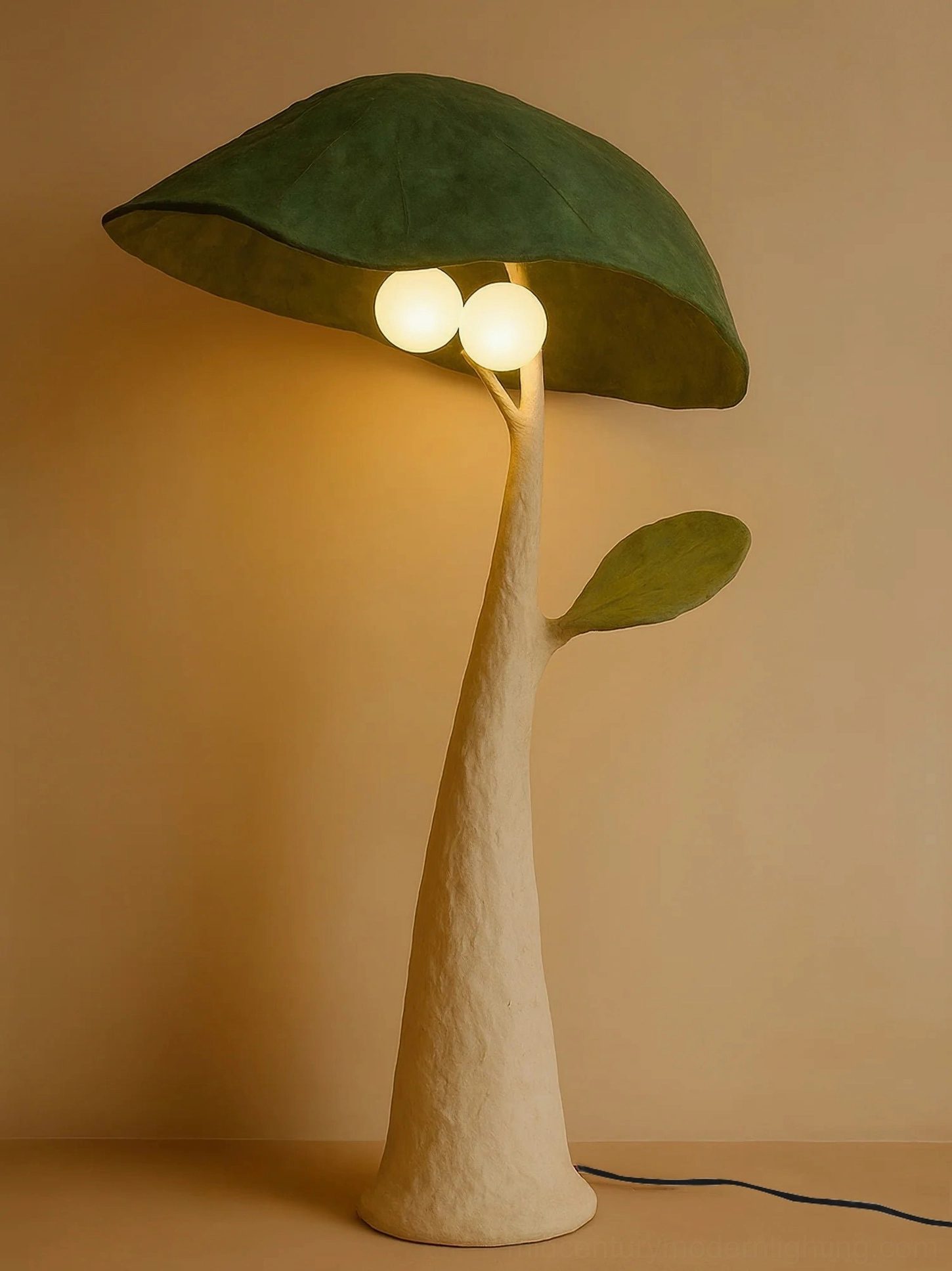 Soloma mushroom floor lamp lit with warm ambient glow in interior setting, right three-quarter angle showing soft illumination and botanical aesthetic