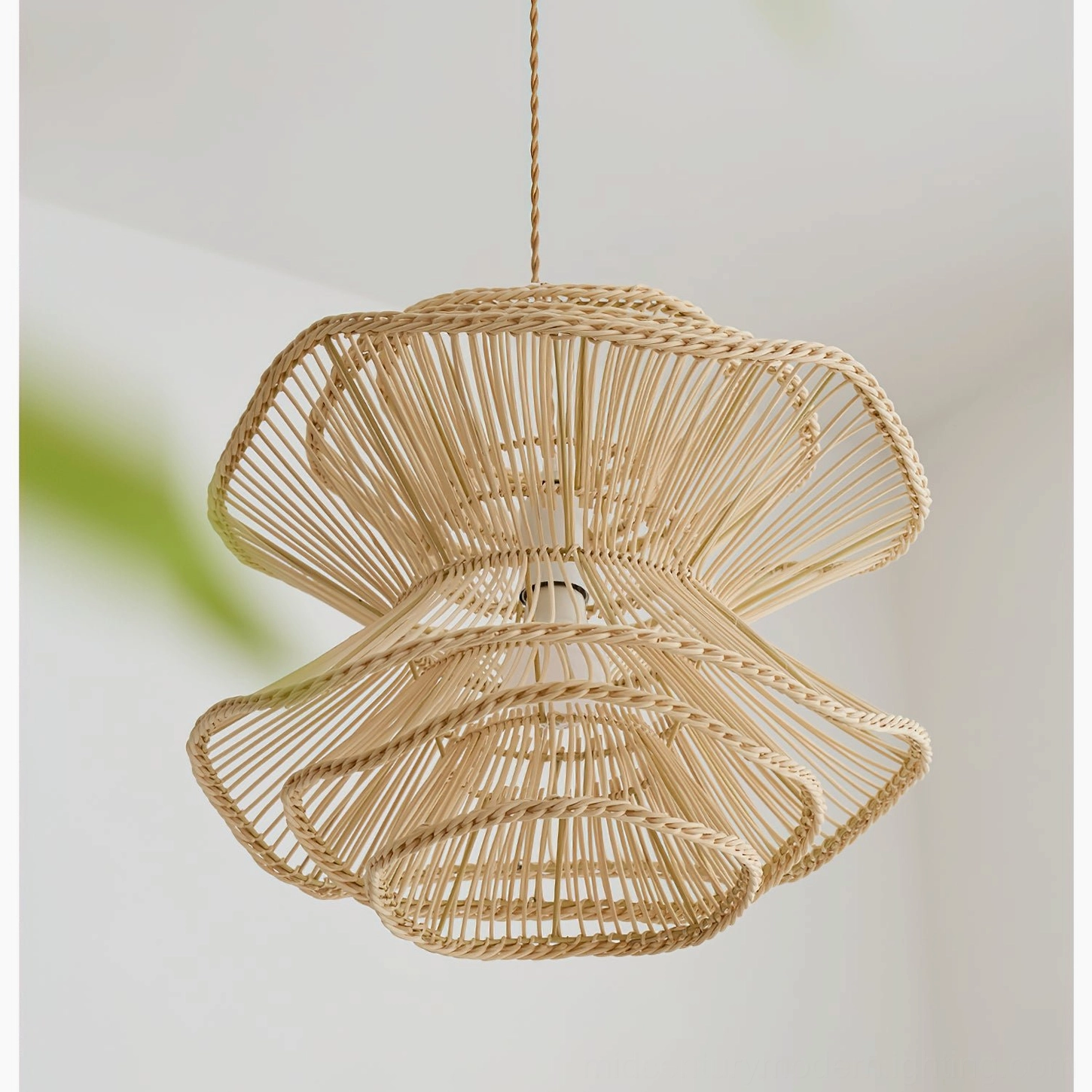 Bottom-front close-up view of Sombra rattan pendant showing open woven structure, natural light brown finish and sculptural construction