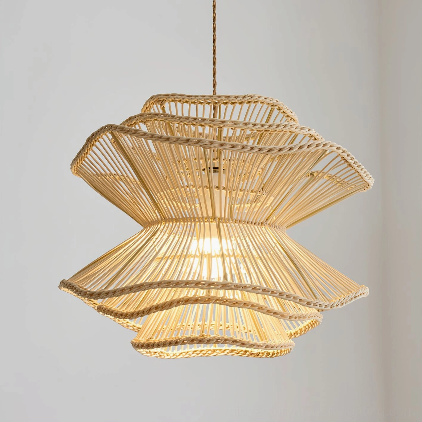Close-up frontal view of Sombra rattan pendant lamp displaying intricate woven texture and warm interior glow with double flared layers