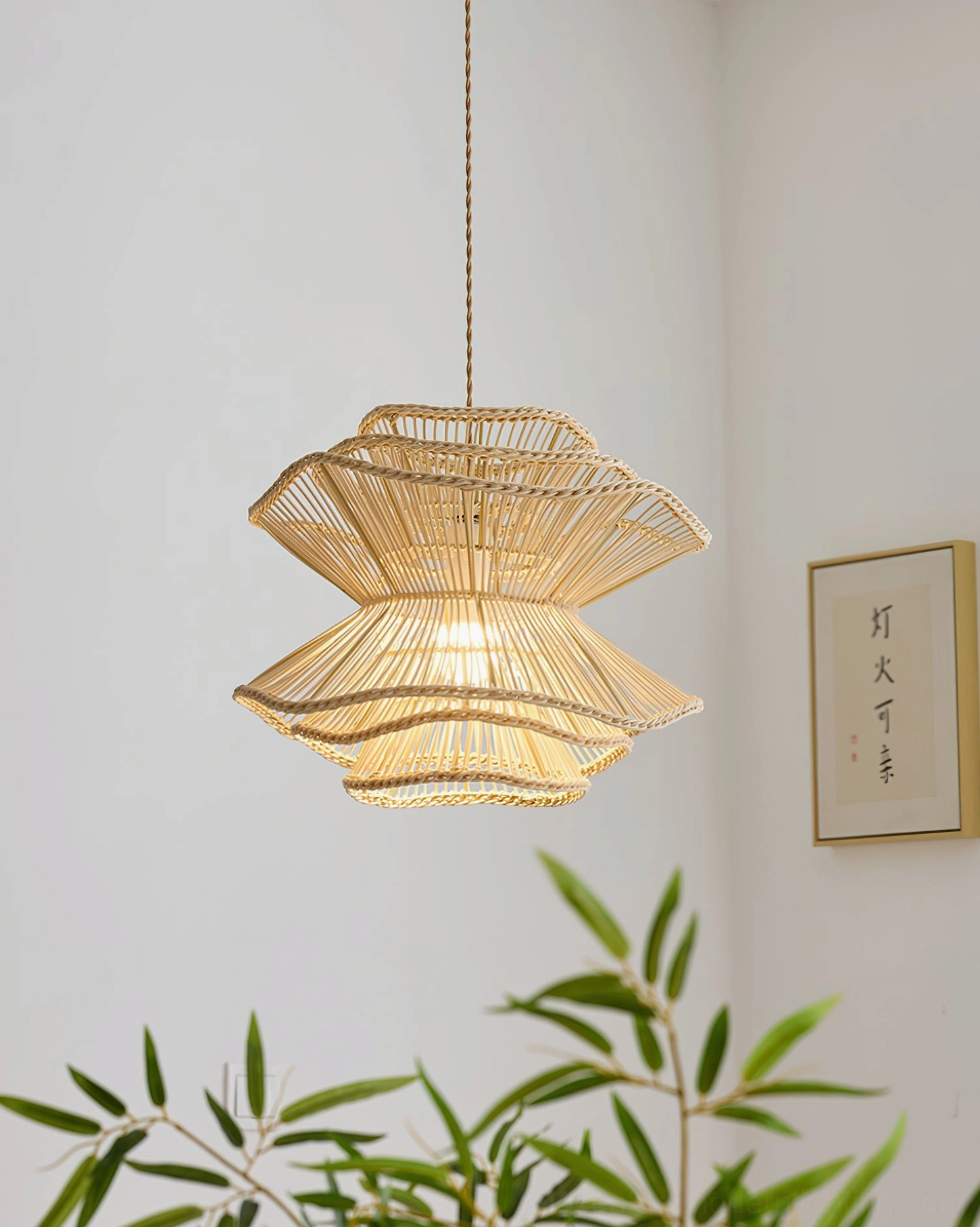 Sombra rattan pendant light suspended in minimalist dining corner with botanical decor, showcasing bohemian home aesthetic