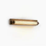 Somerset Fluted Linear Wall Sconce - Antique Brass finish with clear ribbed acrylic diffuser, side view showing Art Deco geometric design