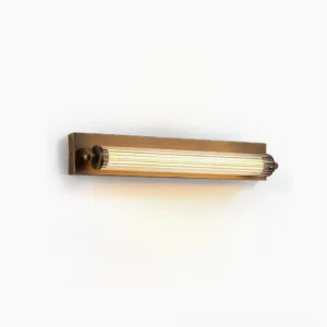 Somerset Fluted Linear Wall Sconce - Antique Brass finish with clear ribbed acrylic diffuser, side view showing Art Deco geometric design