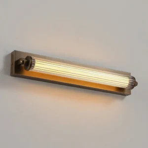 Close-up detail of Somerset sconce brass mounting bracket and adjustment mechanism on light gray wall