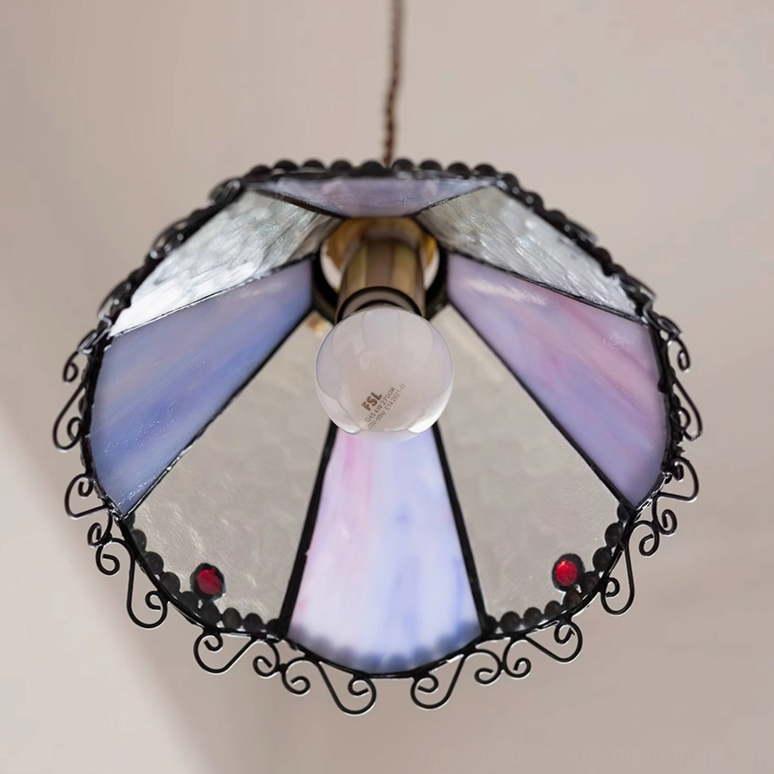 Bottom underside view of Sonoma pendant lamp showing exposed bulb socket, brass metal frame and decorative edge trim details