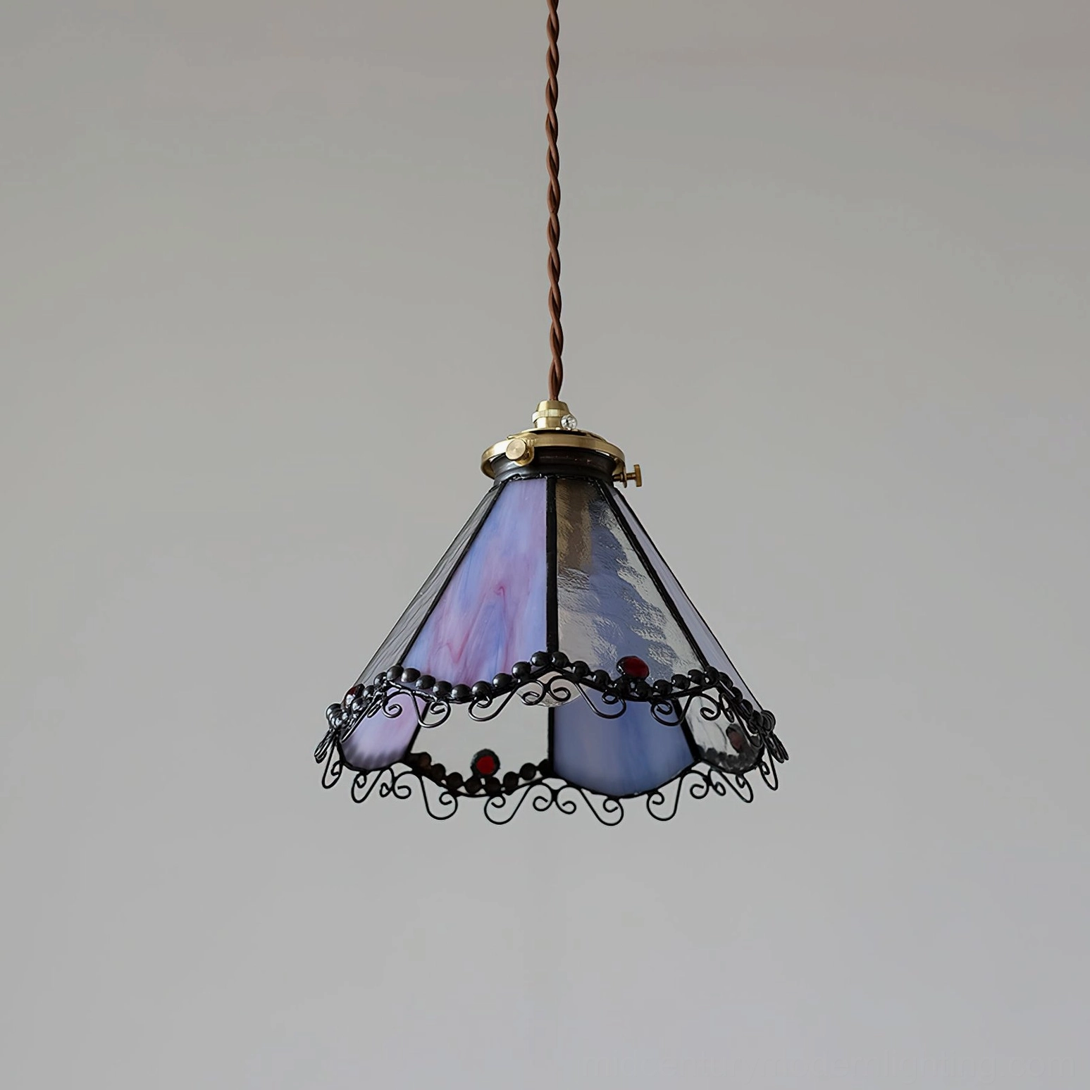 Side profile of Sonoma stained glass pendant lamp showing purple gradient panels with black wrought iron scrollwork trim detail