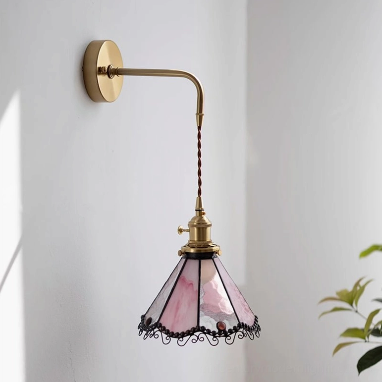 Sonoma Tiffany Model B wall light in pink and white stained glass with elongated brass arm and ornamental black frame trim