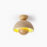 Sonoma travertine ceiling light flush mount with warm wood base, front studio view