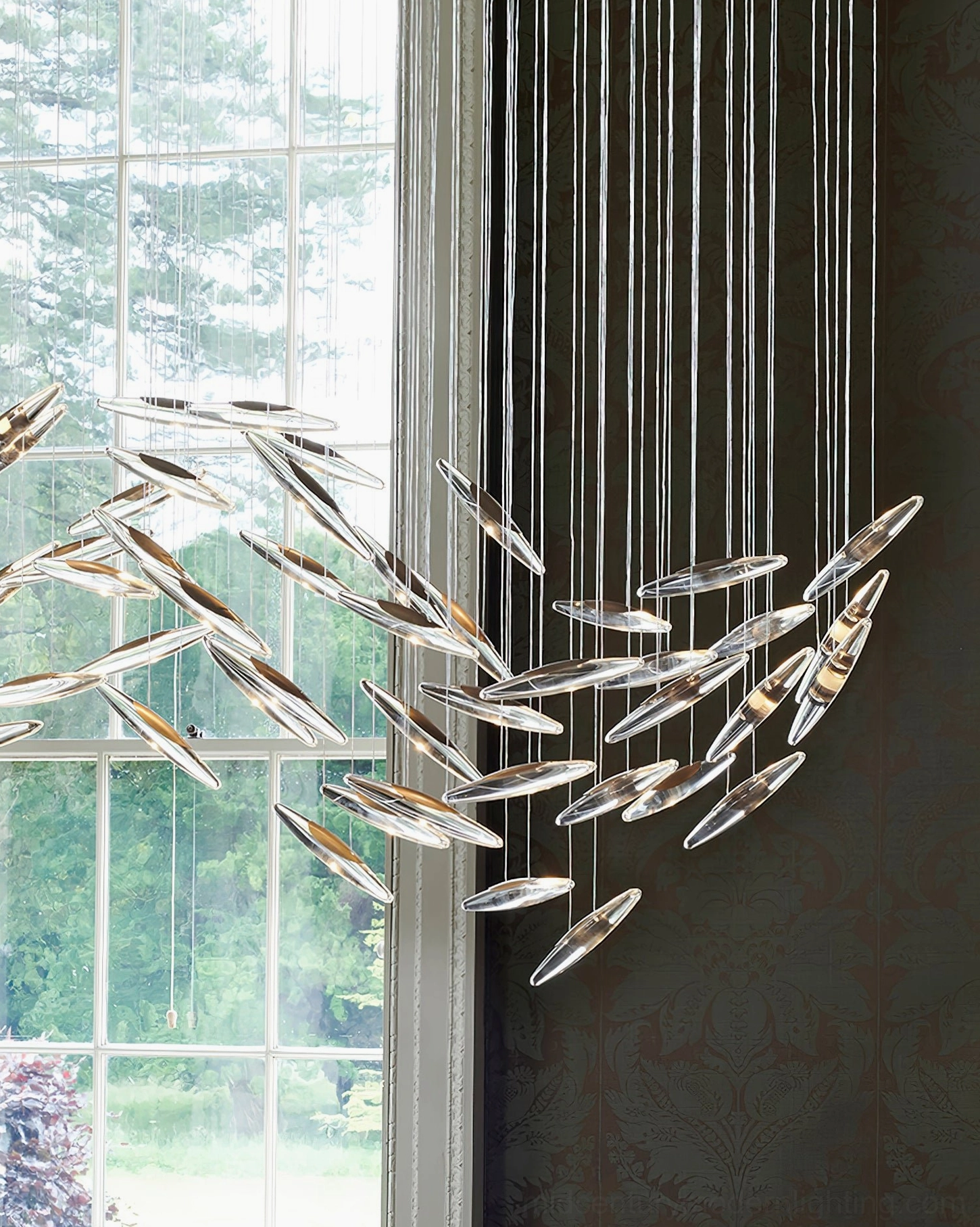 Sophisticated cascading glass chandelier installation demonstrating interior design integration