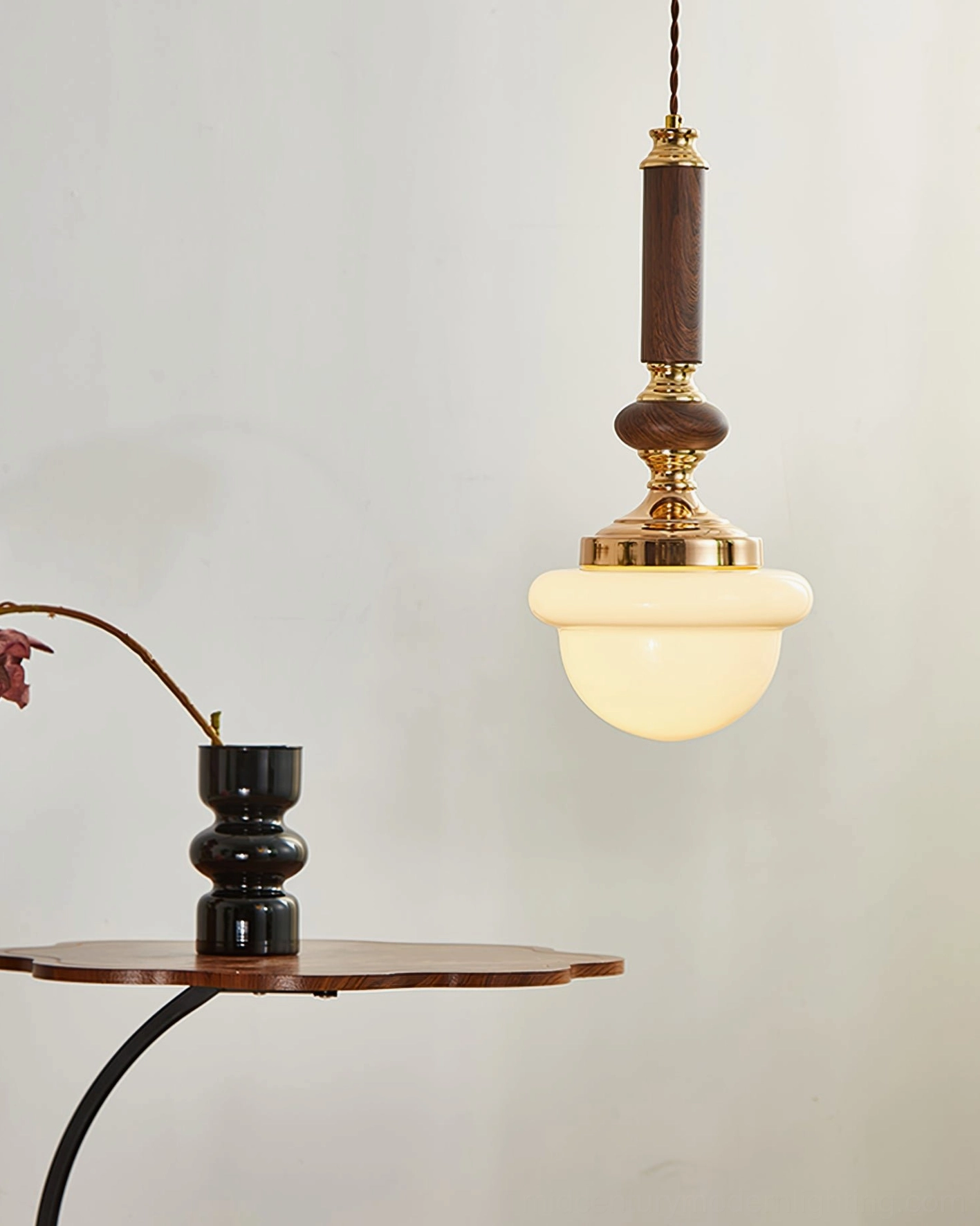 Sorbonne pendant lamp with dark wood hardware and warm glowing glass shade ambient view