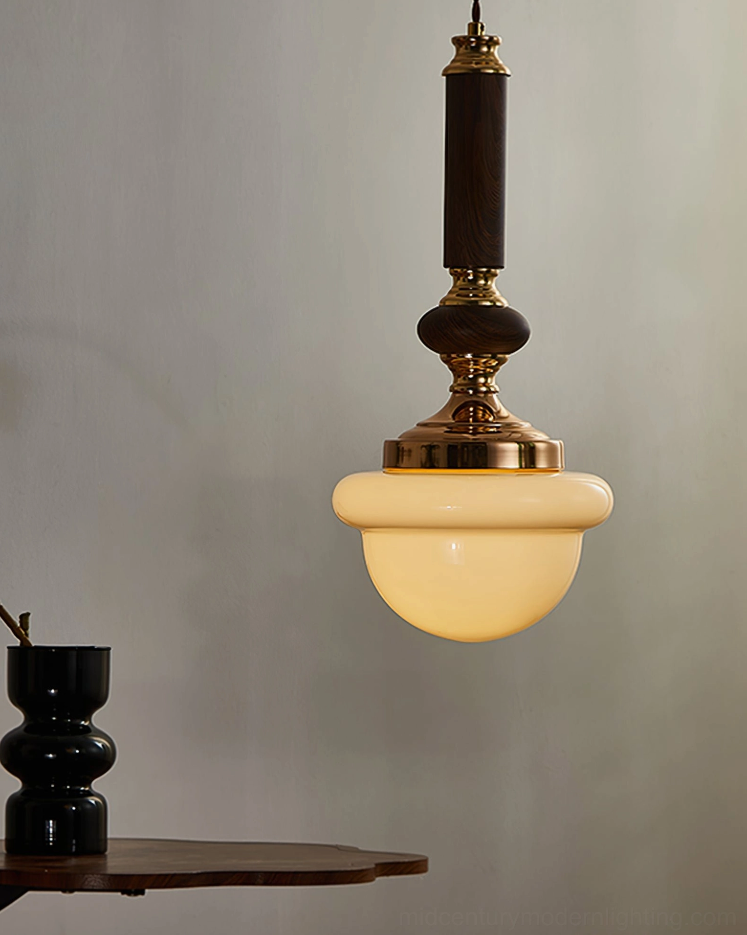 Sorbonne mid-century pendant with dark wood accents and warm glass shade side angle view