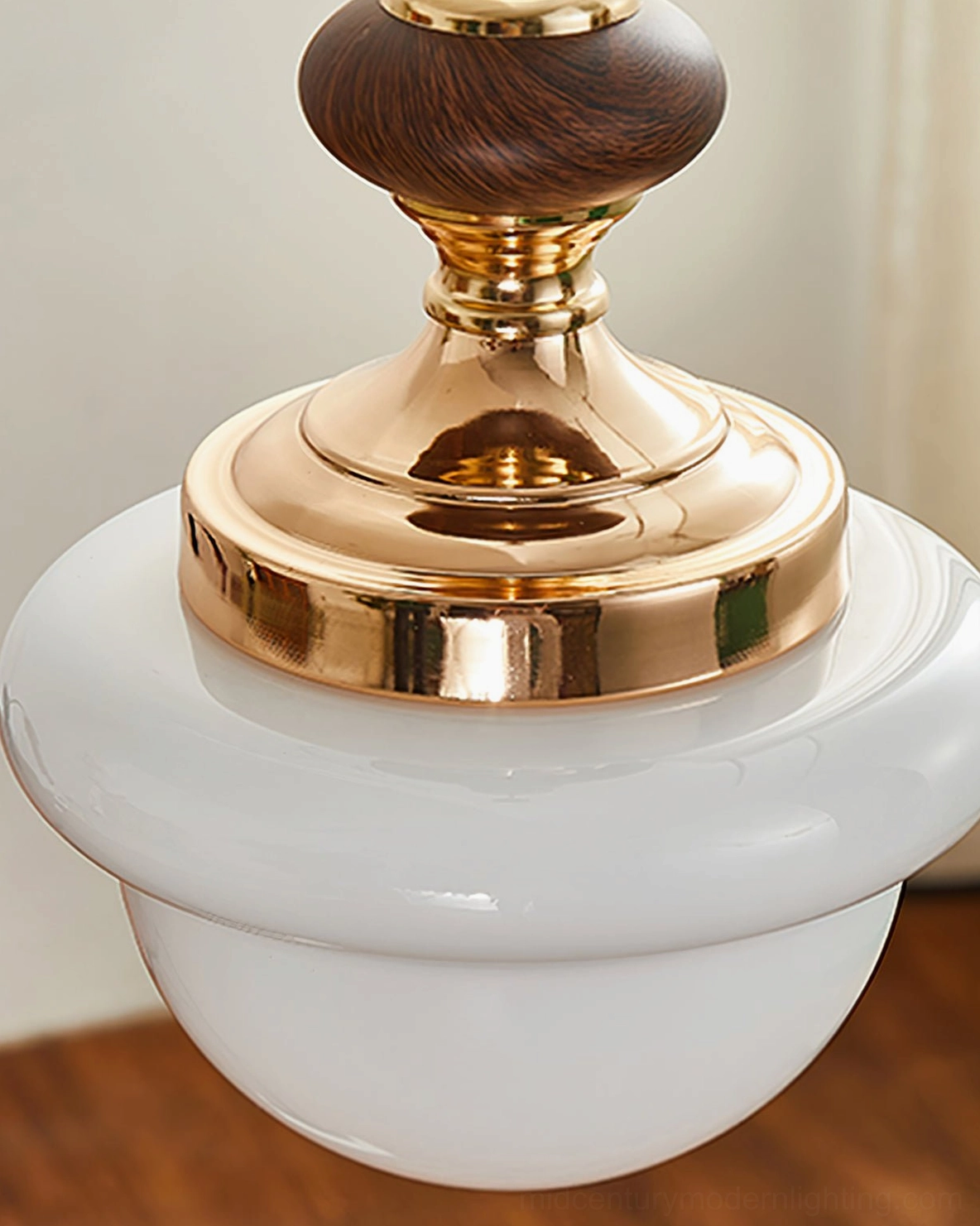 Overhead close-up of Sorbonne pendant highlighting polished gold hardware and glossy glass dome