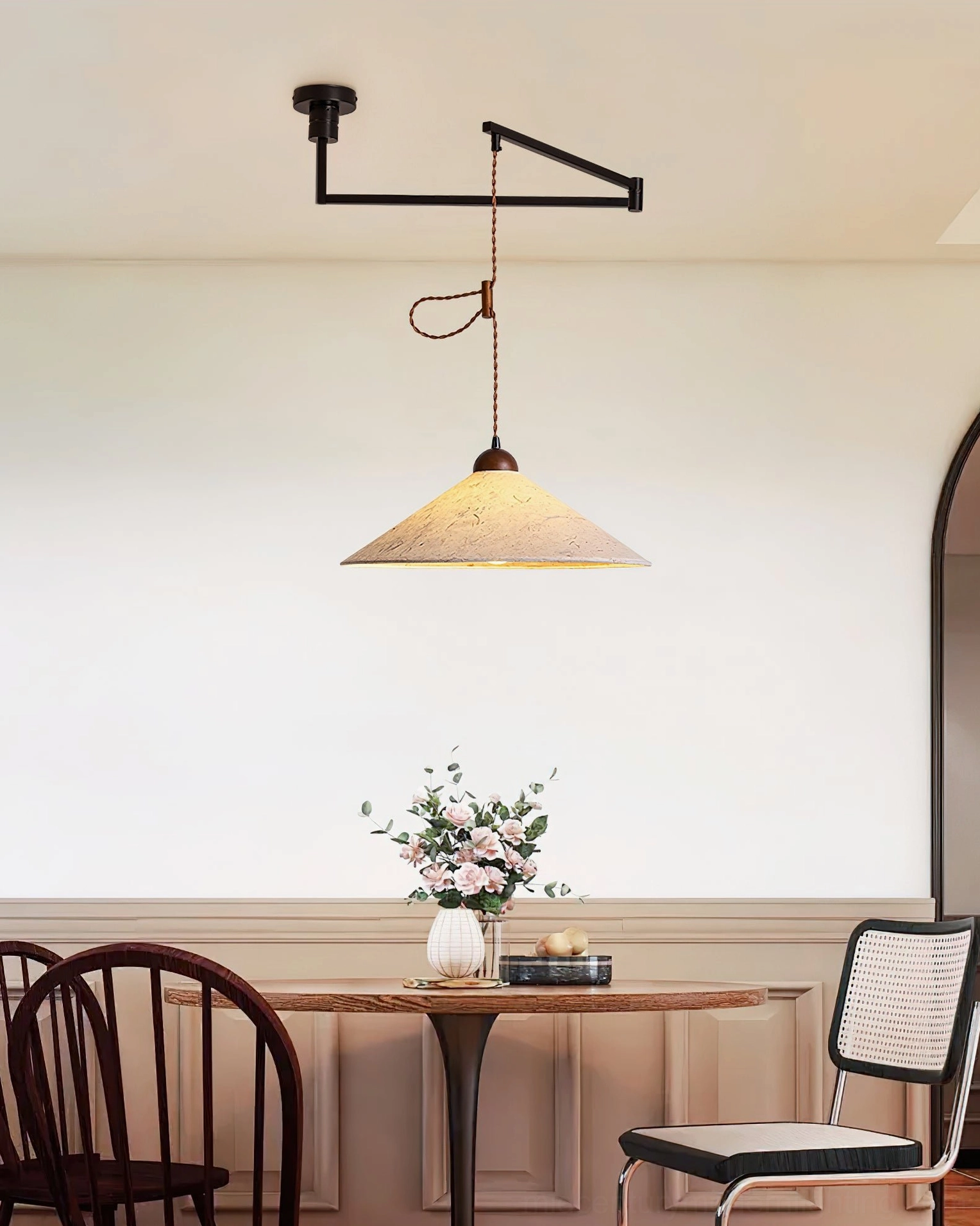 Soren Swing Arm Pendant Light compact dining area installation, side view with muted neutral color scheme and soft warm tone