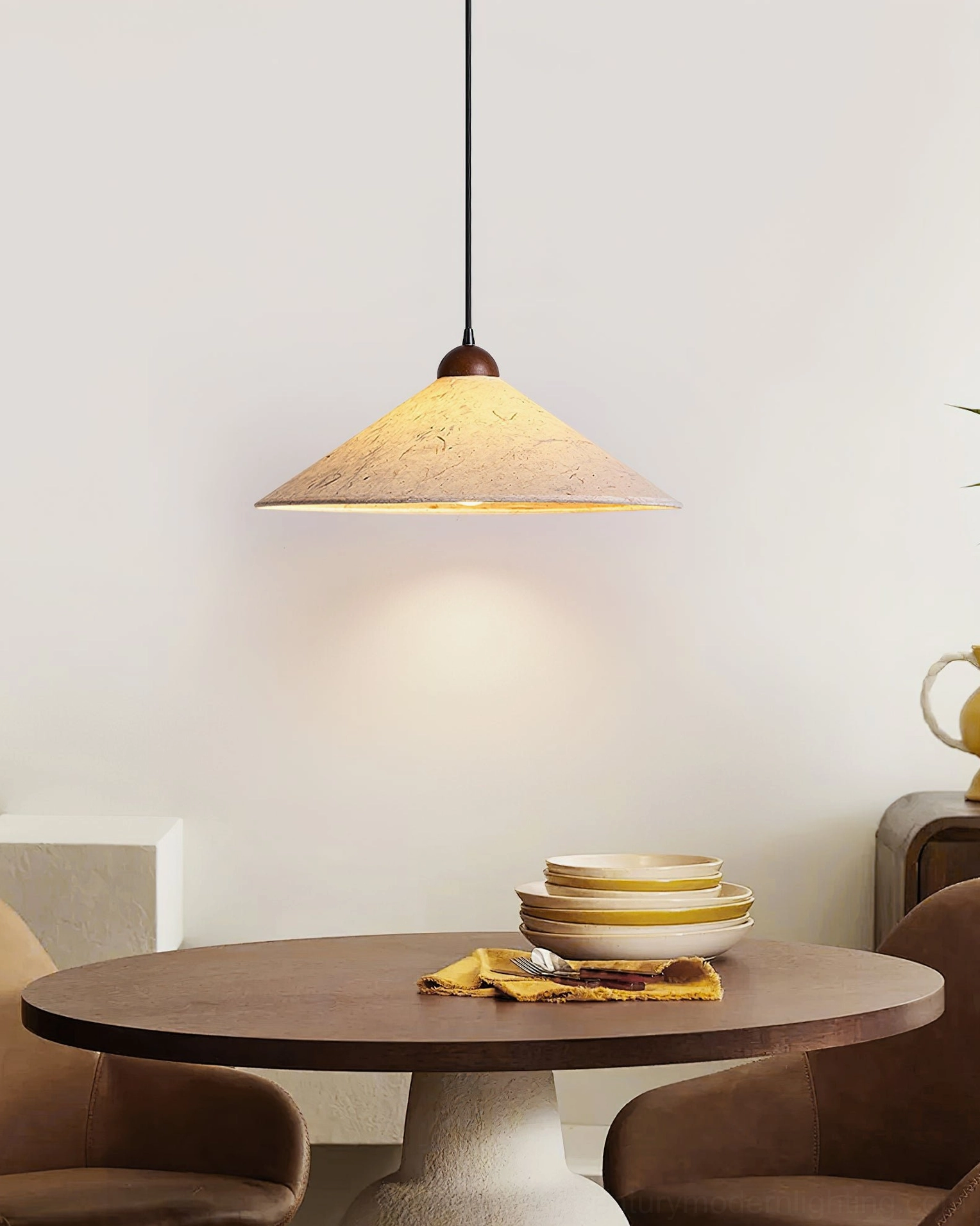 Soren Swing Arm Pendant Light front low-angle view in small dining spot, earthy warm tone decor setting