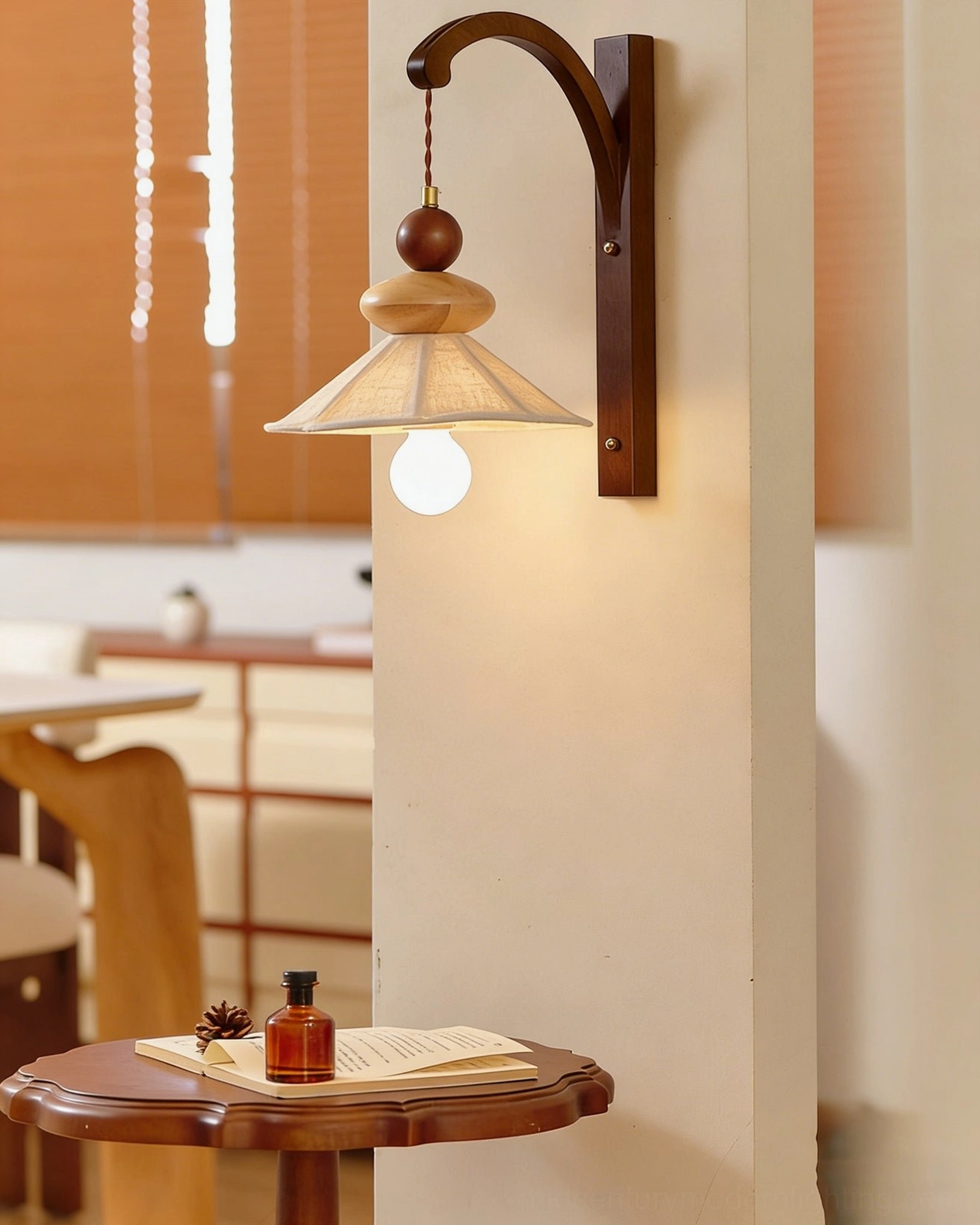 Soren wall sconce installed in dining lounge setting with wooden furniture and window blinds