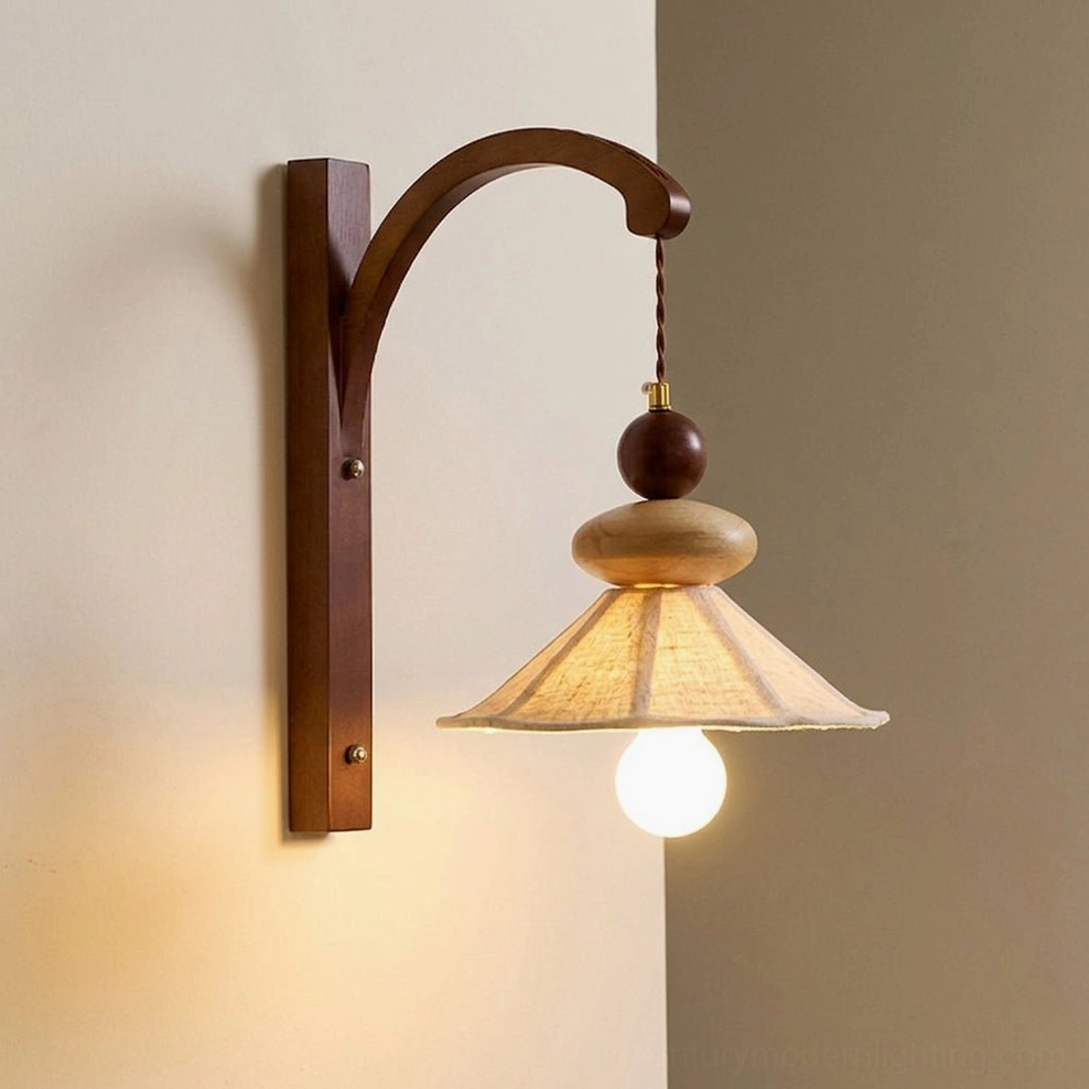 Lit Soren fabric wall sconce creating warm ambient light on beige wall - close-up eye-level view