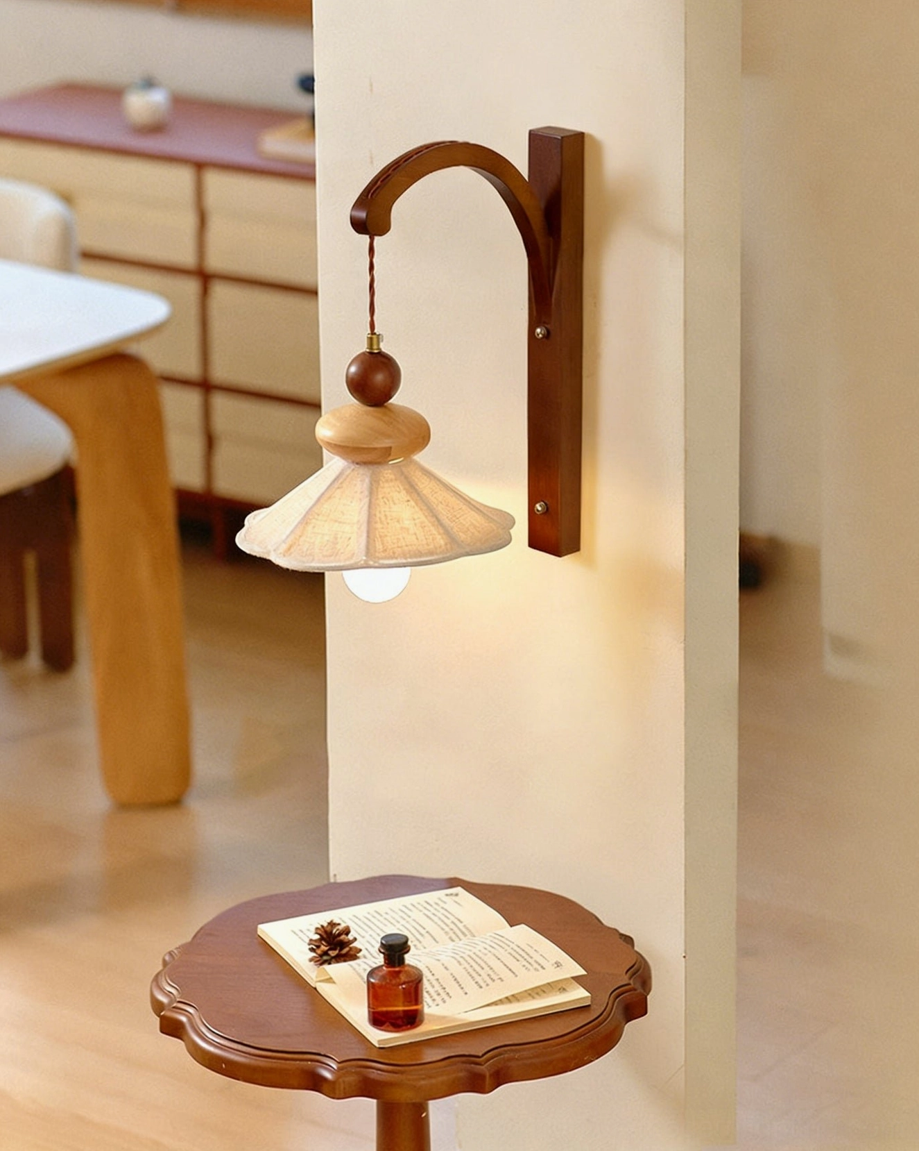 Mid-century modern Soren wall sconce above side table in residential living room with warm lighting