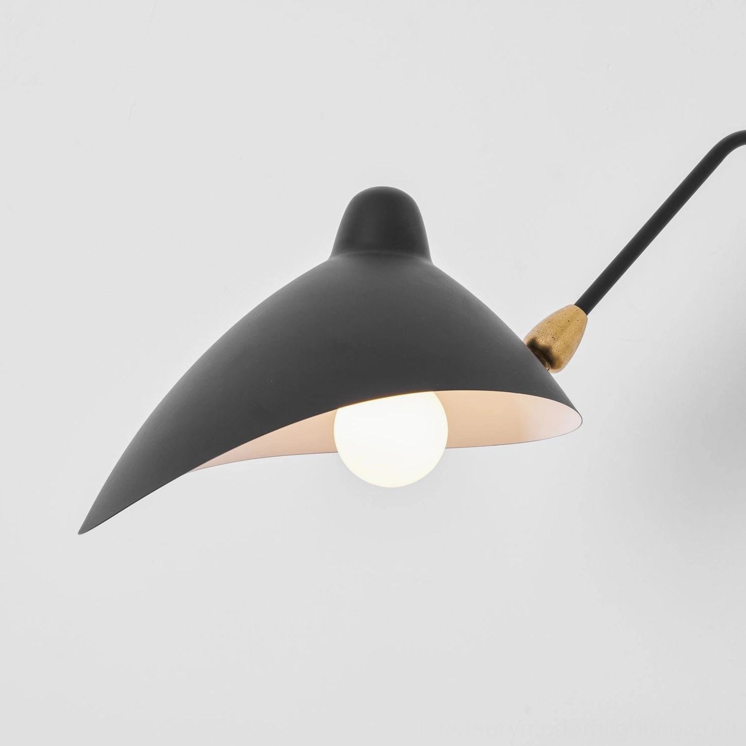 Matte finish spider wall sconce demonstrating adjustable shade pivot joint in detail